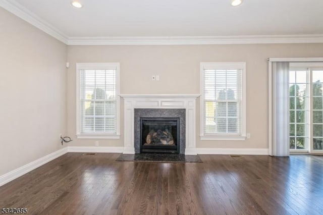 unfurnished living room featuring a premium fireplace, baseboards, dark wood-style floors, and ornamental molding