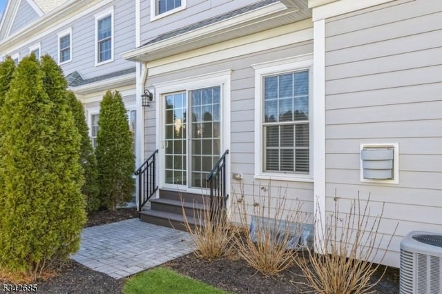 doorway to property with central AC unit