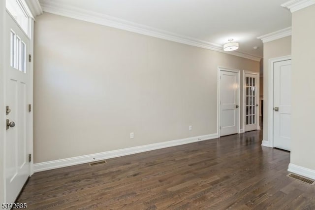 entryway featuring visible vents, baseboards, dark wood-type flooring, and ornamental molding