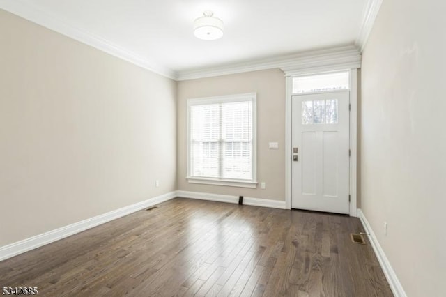 foyer with visible vents, baseboards, dark wood finished floors, and crown molding