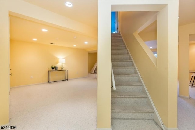 stairs with baseboards, carpet floors, and recessed lighting