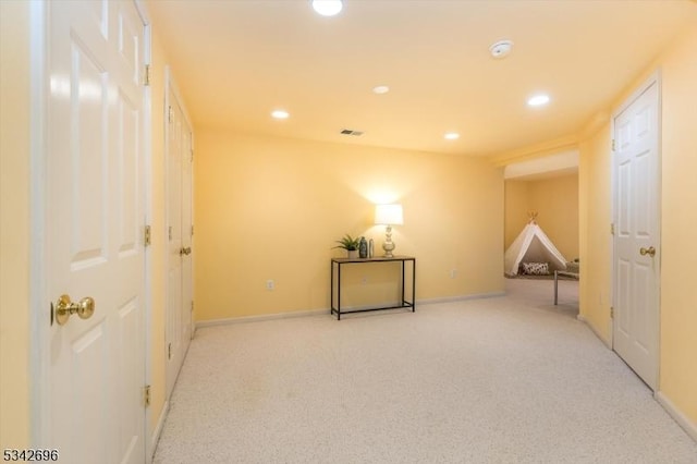 unfurnished room featuring recessed lighting, light carpet, visible vents, and baseboards