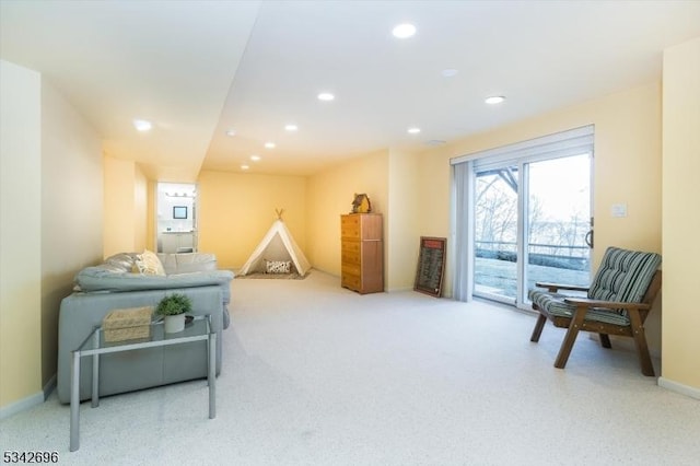 living area featuring recessed lighting and baseboards