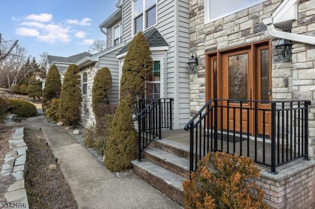 doorway to property featuring stone siding