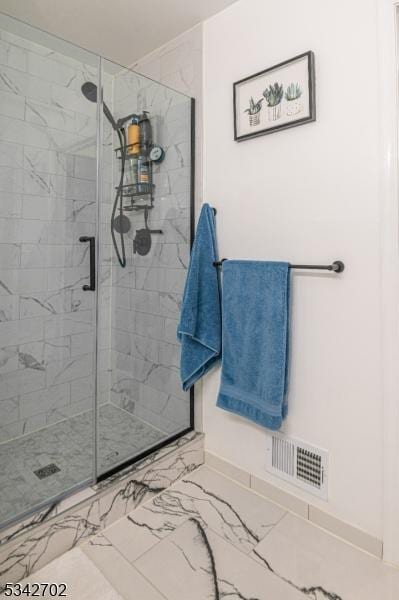 bathroom featuring visible vents, marble finish floor, and a stall shower