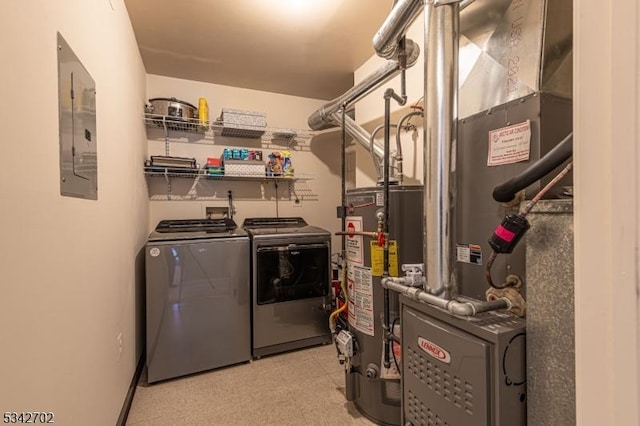 clothes washing area with electric panel, washing machine and dryer, water heater, light floors, and laundry area