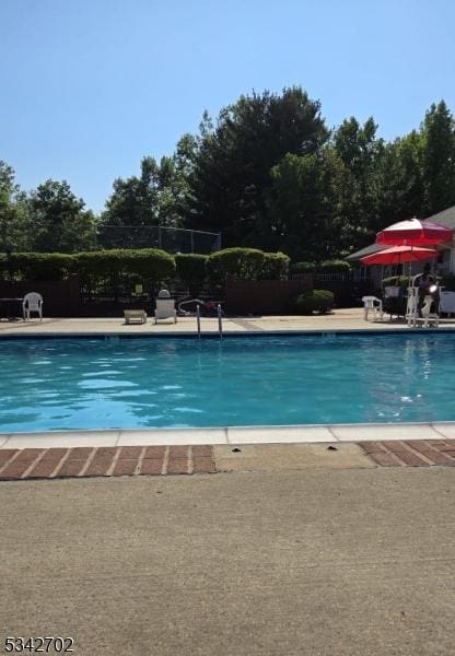 pool featuring a patio area and fence