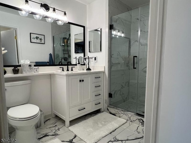 bathroom with vanity, a shower stall, toilet, and marble finish floor