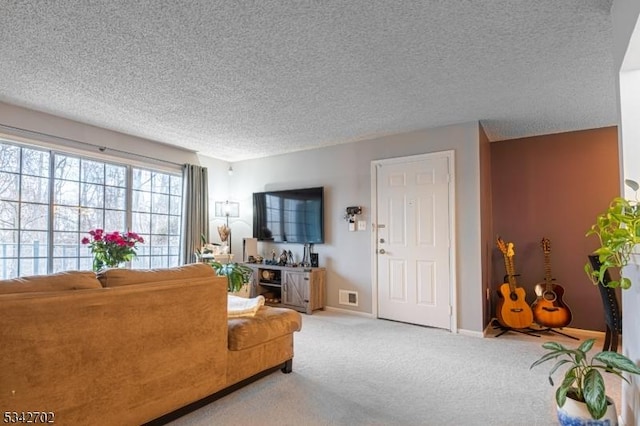 living room featuring visible vents, baseboards, a textured ceiling, and carpet flooring