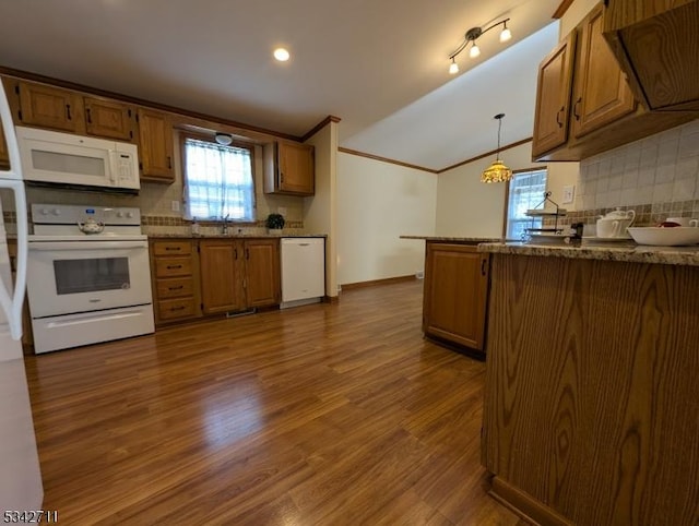 kitchen featuring dark wood-type flooring, white appliances, brown cabinetry, and backsplash