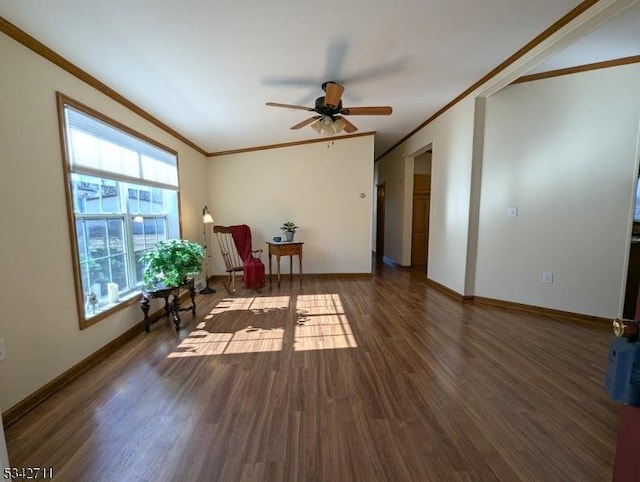 living area with ornamental molding, wood finished floors, a ceiling fan, and baseboards