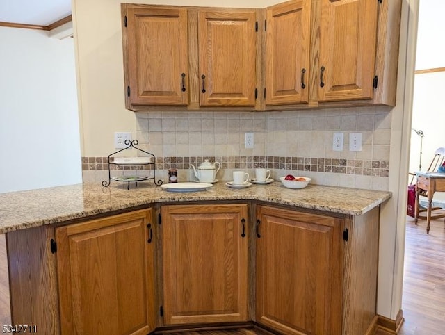 kitchen featuring brown cabinetry and backsplash