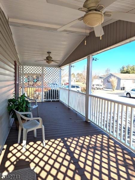 deck with a ceiling fan and a porch