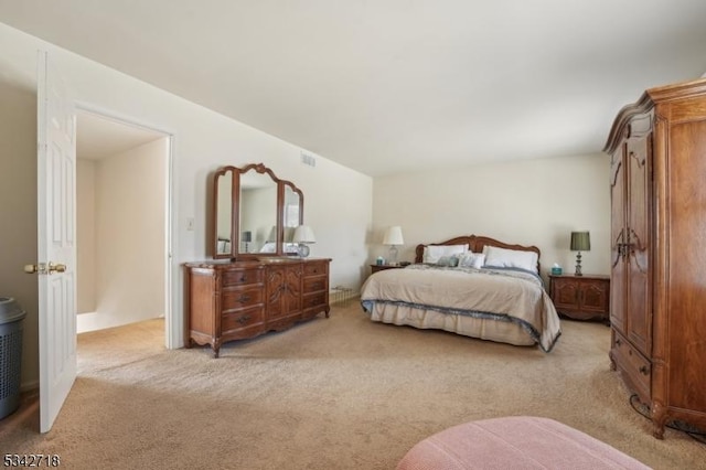 bedroom featuring light colored carpet and visible vents