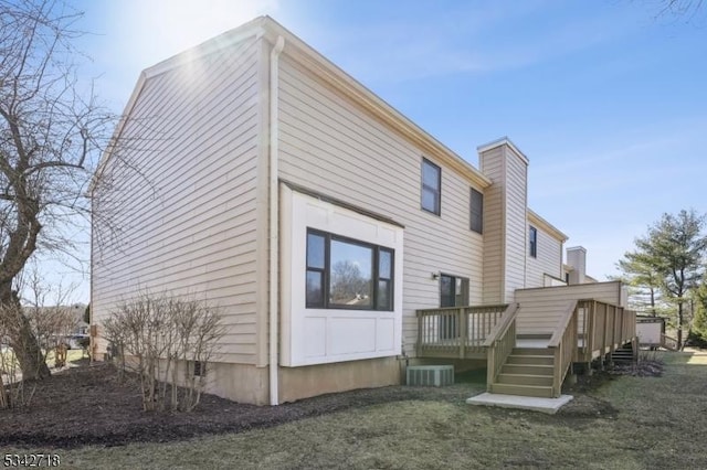 view of side of home featuring a deck and a chimney