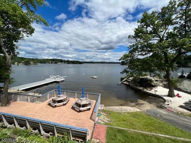 view of dock featuring a deck with water view and a fire pit