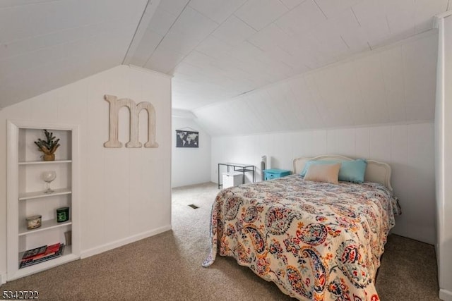 bedroom with carpet floors and vaulted ceiling