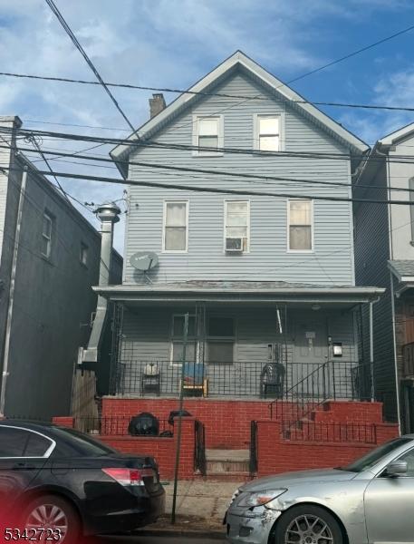 view of front of property with a porch and a chimney