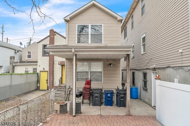 back of property with a patio, fence, and central air condition unit