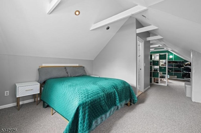 bedroom with lofted ceiling, carpet flooring, and baseboards