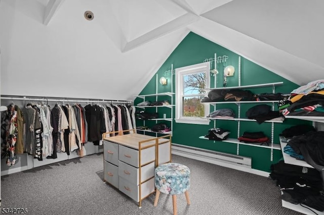 spacious closet featuring a baseboard heating unit, vaulted ceiling, and carpet flooring