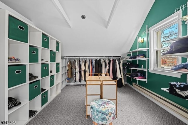 walk in closet with carpet floors, a baseboard radiator, and vaulted ceiling