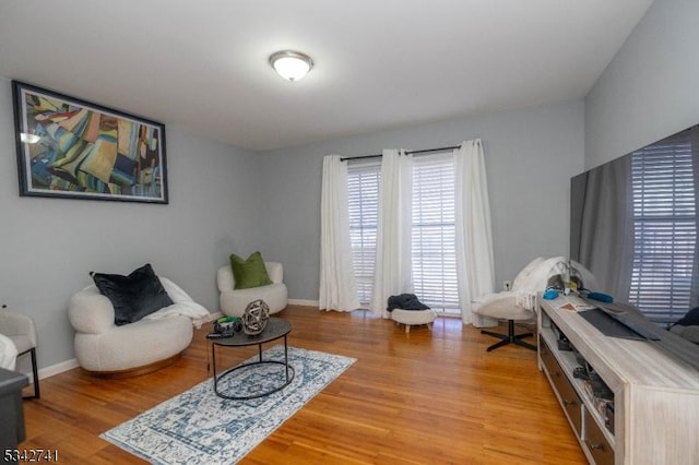 sitting room with light wood-style flooring and baseboards