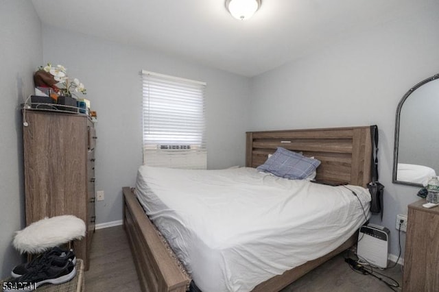 bedroom with baseboards and wood finished floors