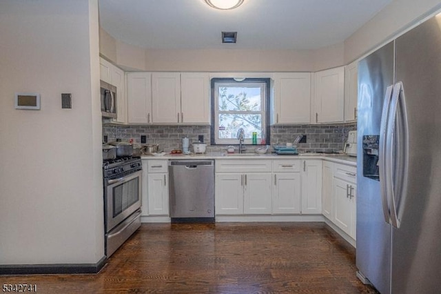 kitchen featuring white cabinetry, appliances with stainless steel finishes, backsplash, and a sink