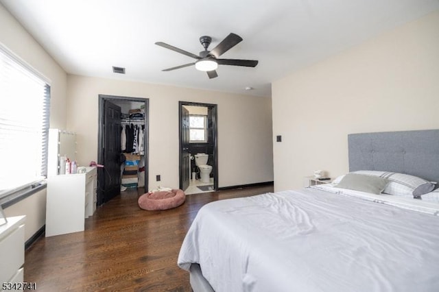 bedroom with ceiling fan, wood finished floors, visible vents, a spacious closet, and a closet