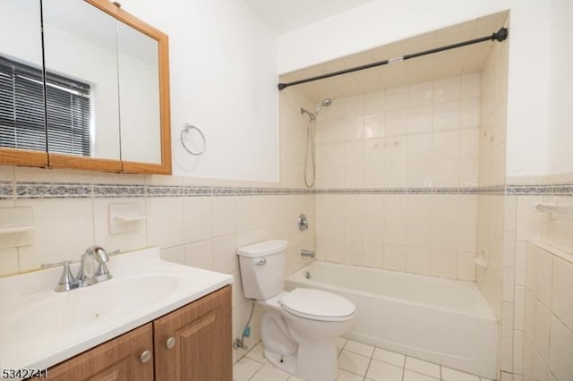 bathroom with shower / bathtub combination, tile patterned flooring, toilet, vanity, and tile walls