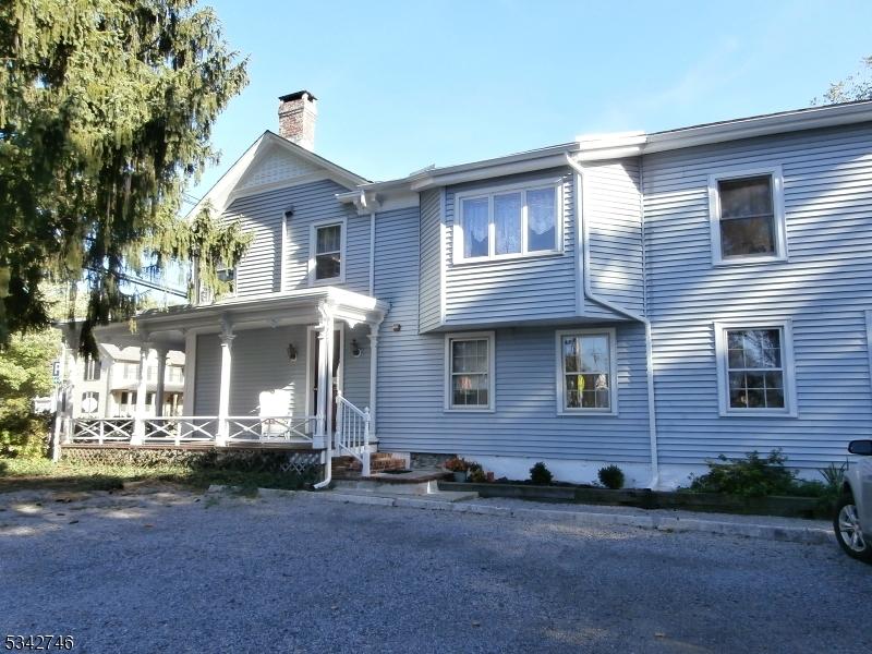 view of front of house with covered porch and a chimney