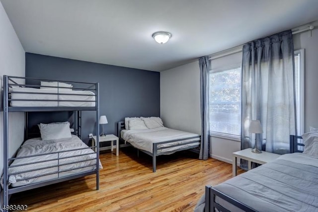 bedroom featuring baseboards and light wood-style flooring