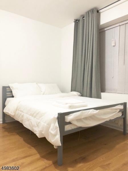 bedroom with wood finished floors