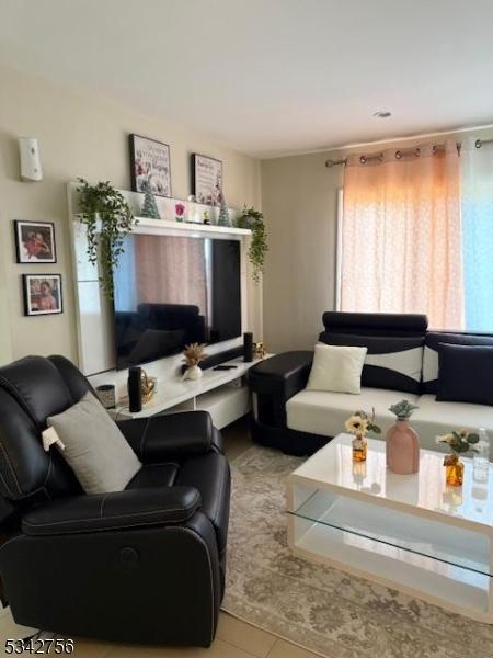 living area featuring tile patterned floors