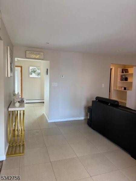 living room featuring a baseboard radiator, baseboards, and light tile patterned flooring