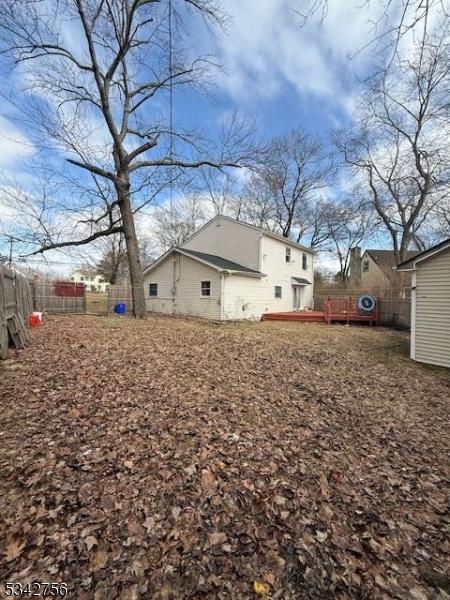 view of yard featuring a deck and fence