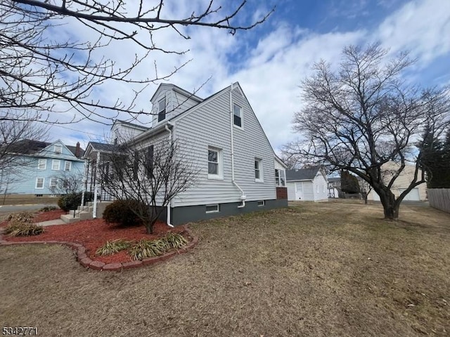 view of side of property featuring a yard