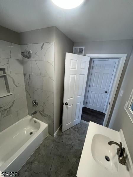 full bath featuring marble finish floor,  shower combination, vanity, and visible vents