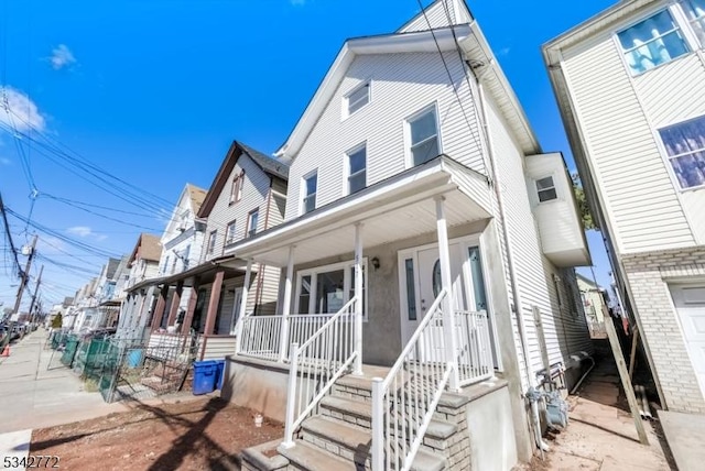 townhome / multi-family property with a porch