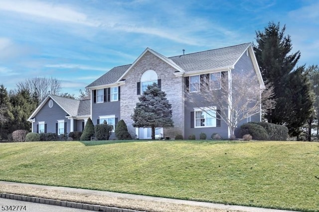 view of front of home featuring stone siding and a front yard