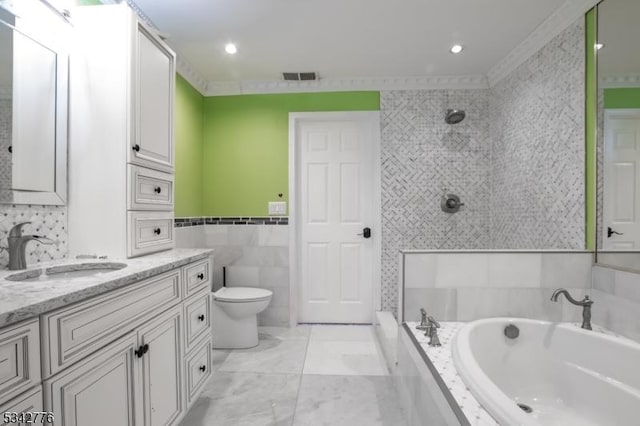 full bathroom featuring a garden tub, vanity, visible vents, tile walls, and marble finish floor