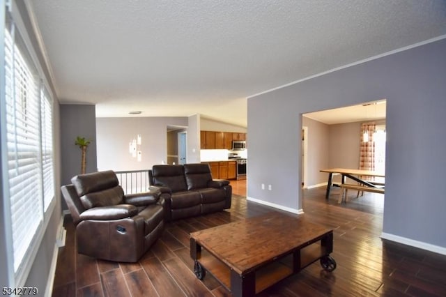 living room featuring dark wood finished floors, plenty of natural light, and baseboards
