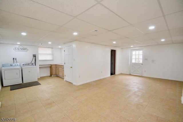 below grade area with recessed lighting, washer and dryer, a paneled ceiling, and baseboards