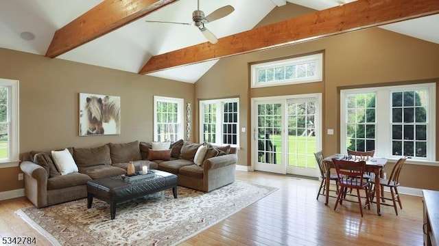 living room with light wood-style floors, ceiling fan, and baseboards