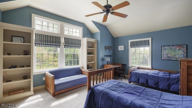 bedroom with vaulted ceiling, light carpet, baseboards, and a ceiling fan