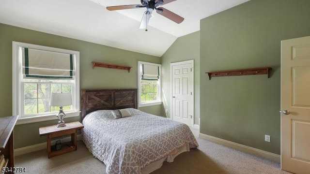 bedroom with baseboards, lofted ceiling, carpet floors, and a ceiling fan