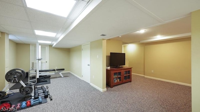 workout area featuring baseboards and carpet flooring