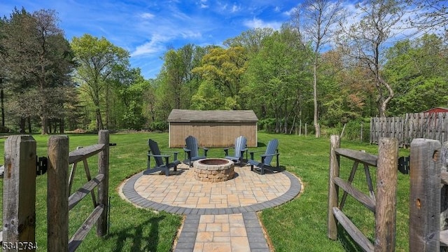view of yard with a fire pit, a patio area, and an outdoor structure