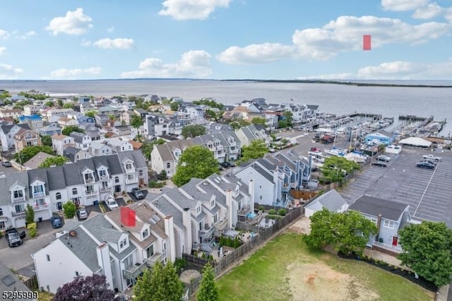 drone / aerial view featuring a residential view and a water view